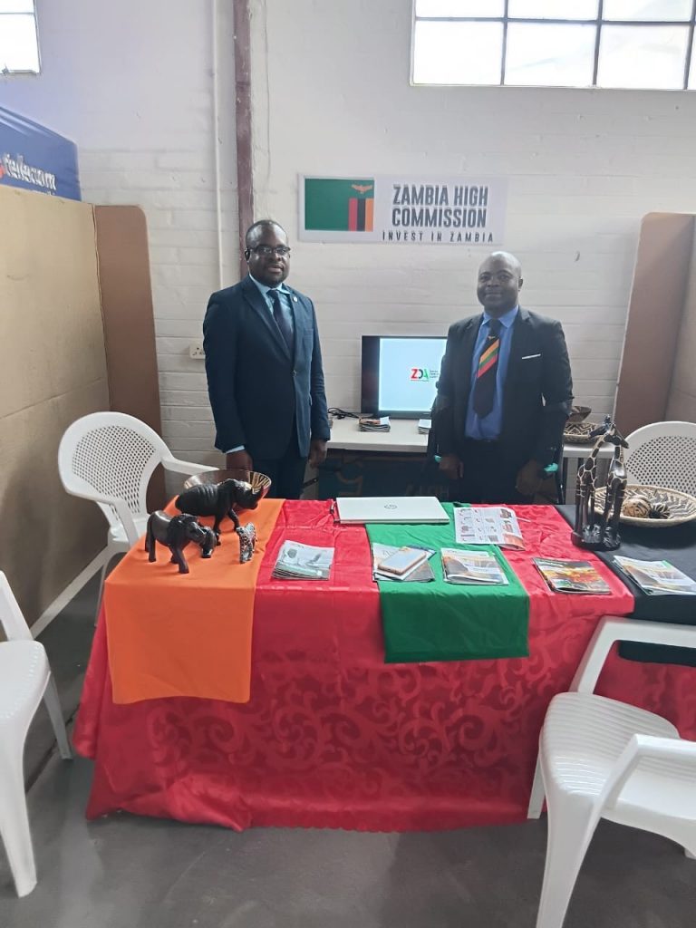 Two Officers pose for a phot at the Mission’s exhibition stand